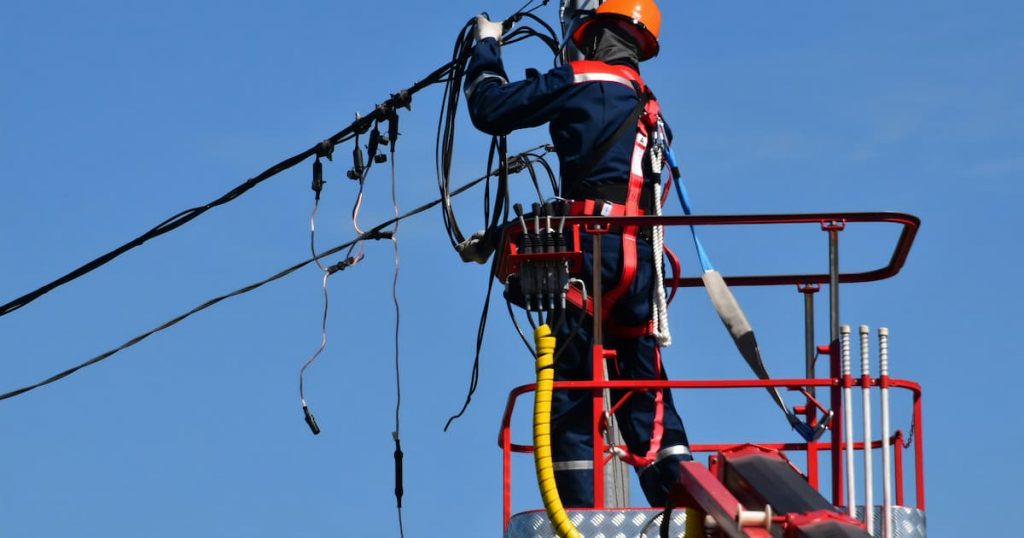Electrician working at height wearing PPE