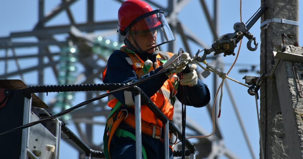Electrician working at height following safety guidance